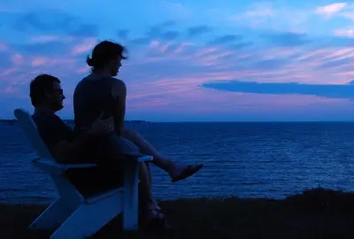 Couples Counselling - Couple sittting and looking toward the sea